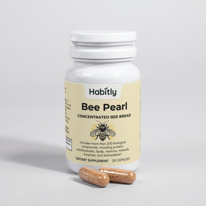 A bottle labeled &quot;Bee Pearl Concentrated Bee Bread Capsules&quot; from Habitly is accompanied by two capsules, featuring concentrated bee bread that contains over 250 biological compounds such as proteins, vitamins, and antioxidants. This gluten-free supplement includes 30 dietary capsules crafted for optimal health.