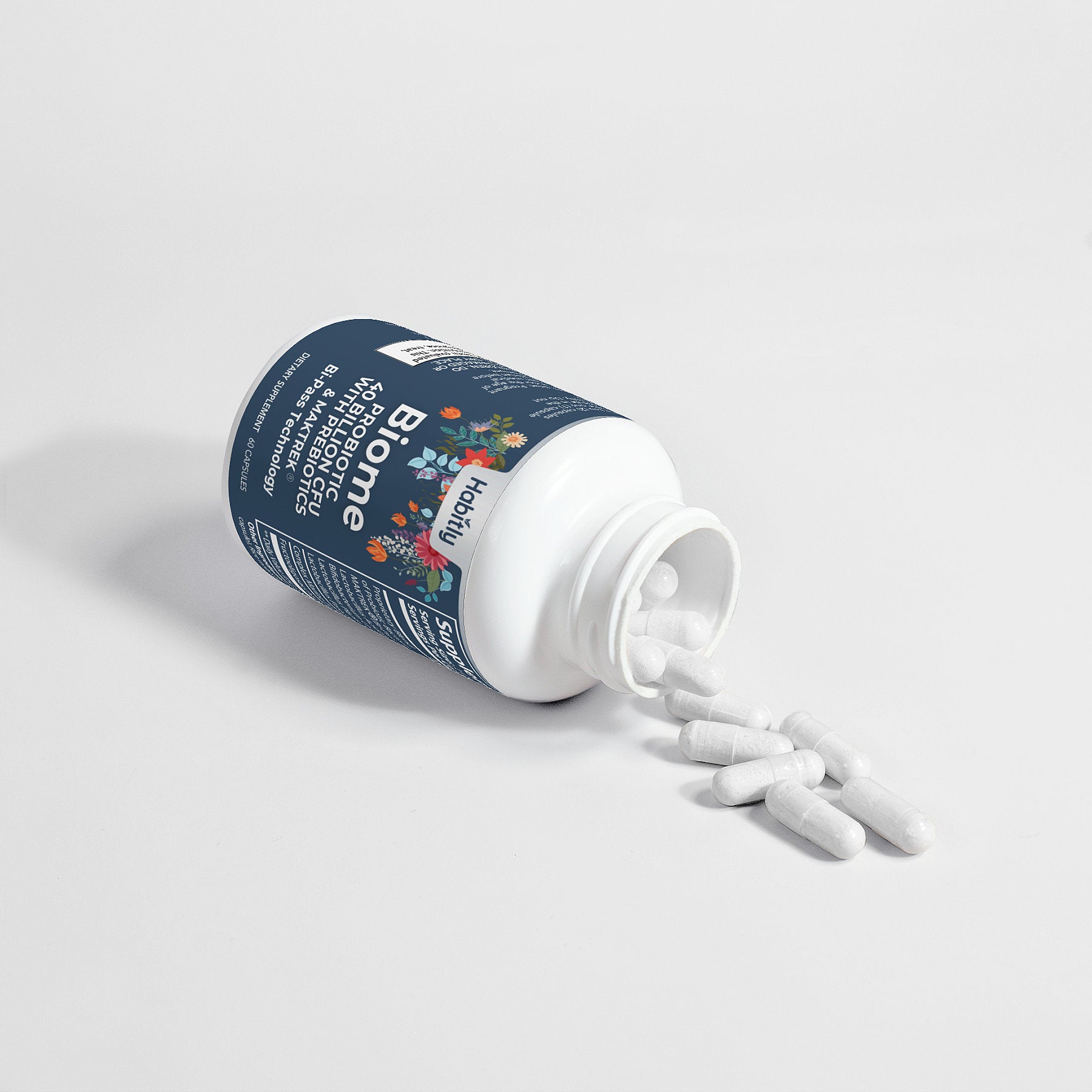 A bottle labeled &quot;Biome Probiotic 40 Billion CFU with MAKTrek&quot; from Habitly is lying on its side against a plain background, with white capsules spilling out. The label features floral graphics and highlights probiotics as essential microbiome support ingredients in this dietary supplement.