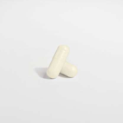 Two white capsules of Habitly&