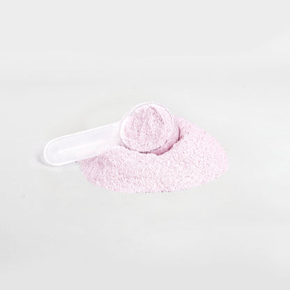 A small white scoop sits in a pile of light pink Habitly&